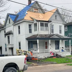 A two story house getting a new roof installed