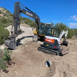 An excavator is preparing a construction site