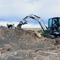 An excavator moving dirt for site preparation