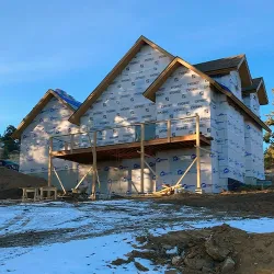 A new home still under construction sits in Colorado snow